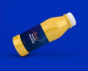 Mockup-of-a-golden-bottle-with-blue-label-in-tilted-position