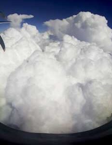 Clouds and sky seen from window of an aircraft