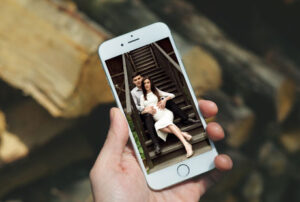 man-holding-i-phone-12-mock-up