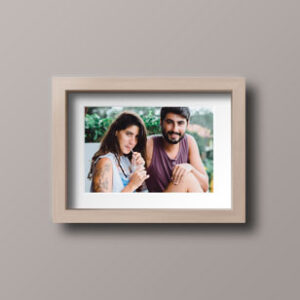young-couple-in-wooden-photo-frame-mock-up