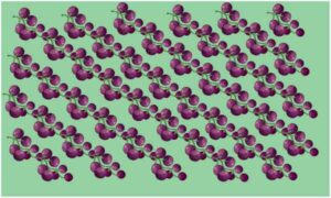 Bunch of black grape make slant line on green surface