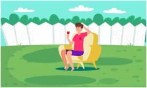 Small boy sit on chair holding juice glass in park