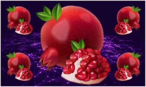 Juicy pomegranate with fresh green leaves