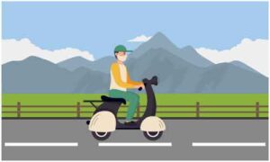 Young man driving scooter on road holding mask and cap near mountains